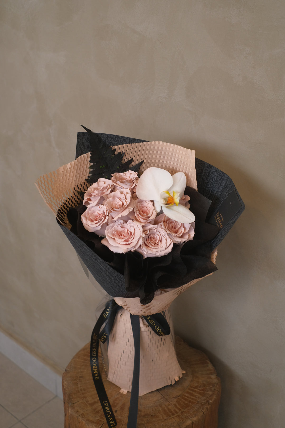Elegant bouquet of 12 roses paired with a stunning Phalaenopsis orchid for a timeless gift. Order online from Bamboo Green Florist, your trusted Penang florist with delivery.