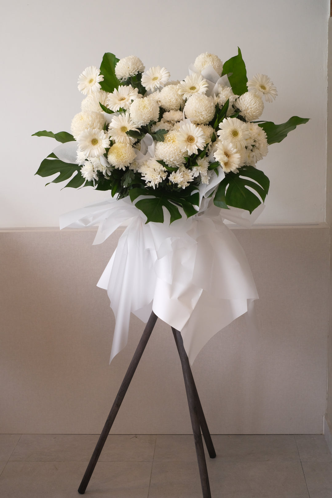 Offer your condolences in a most memorable way and show that you will never forget with this peaceful arrangement. Comprises all in white flowers and greens. For same day condolences flowers delivery in Penang.