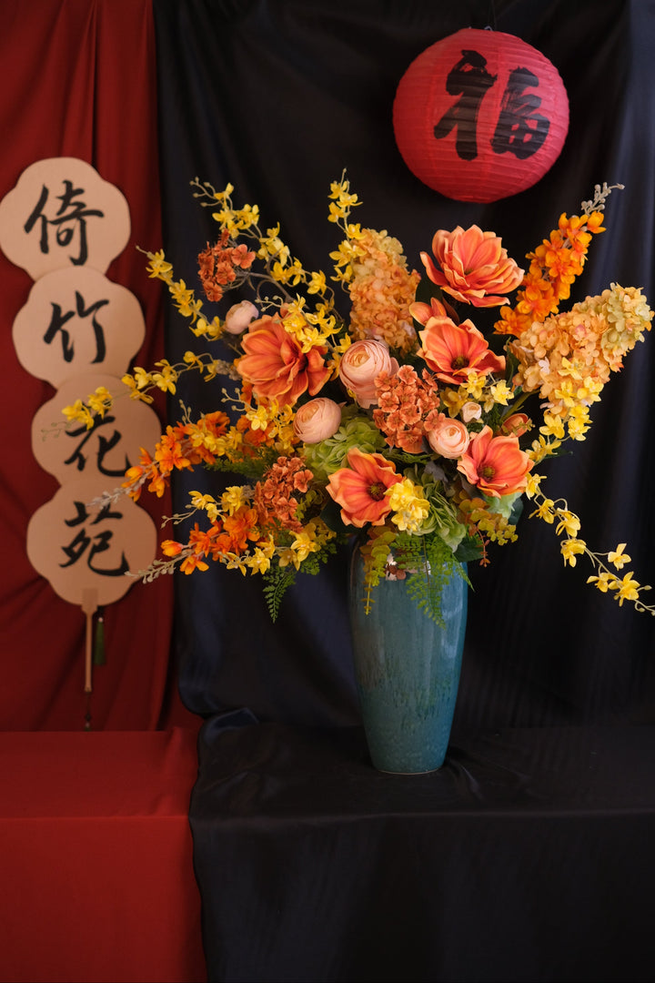 Elegant Chinese New Year floral arrangement featuring vibrant red blooms with purple accents in a red ceramic painted pot, showcasing an oriental design and festive charm."