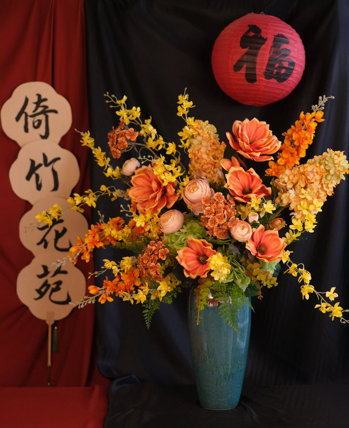 Elegant Chinese New Year floral arrangement featuring vibrant red blooms with purple accents in a red ceramic painted pot, showcasing an oriental design and festive charm."