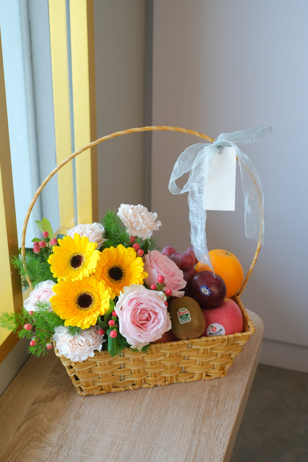 Brightened by fresh blooms, this fruit gift basket is packed with tropical and imported fruits. Penang florist, Order online, deliver same day.