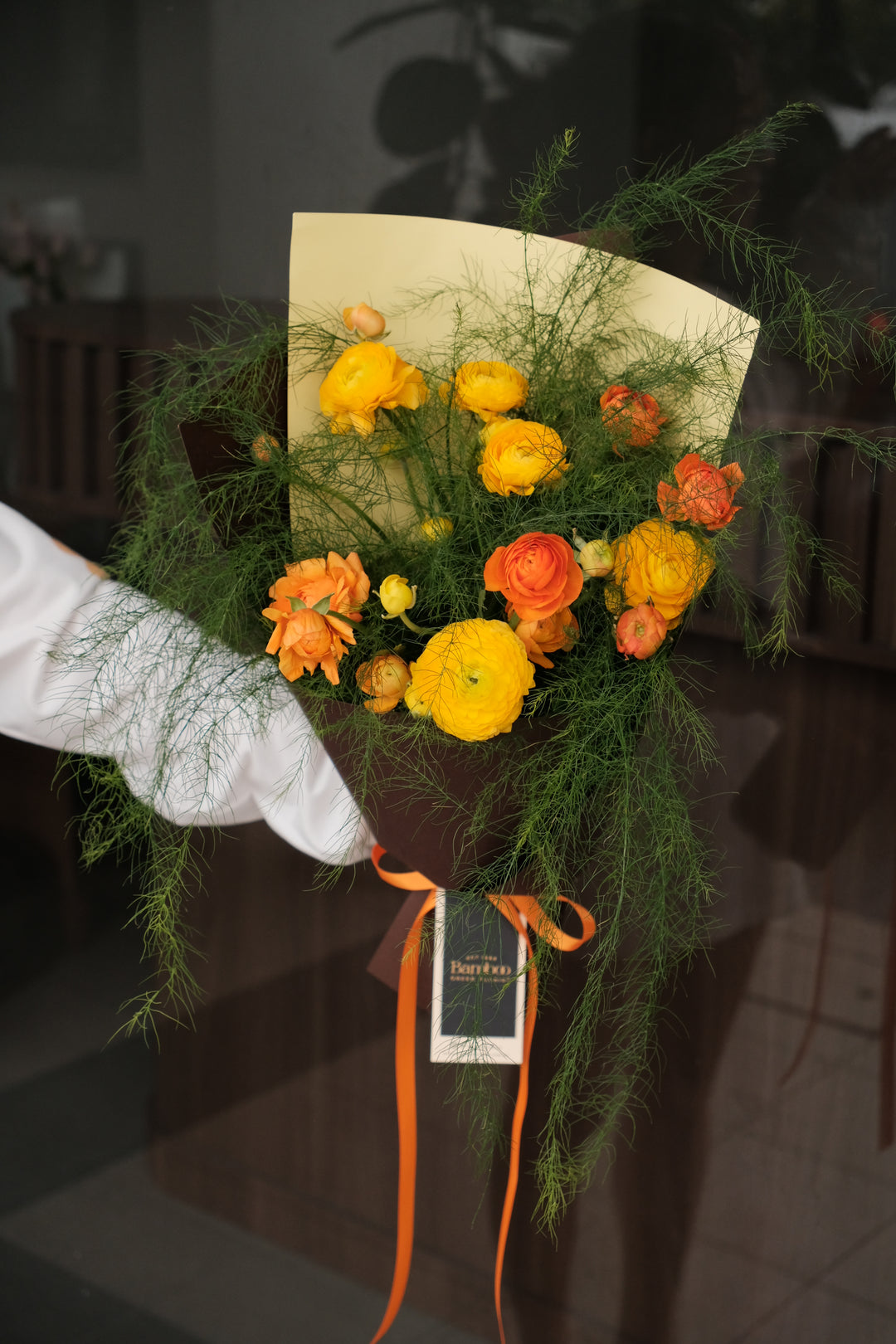 Canelé de Fleur bouquet with fresh ranunculus and cocoa brown wrapping by Bamboo Green Florist Penang