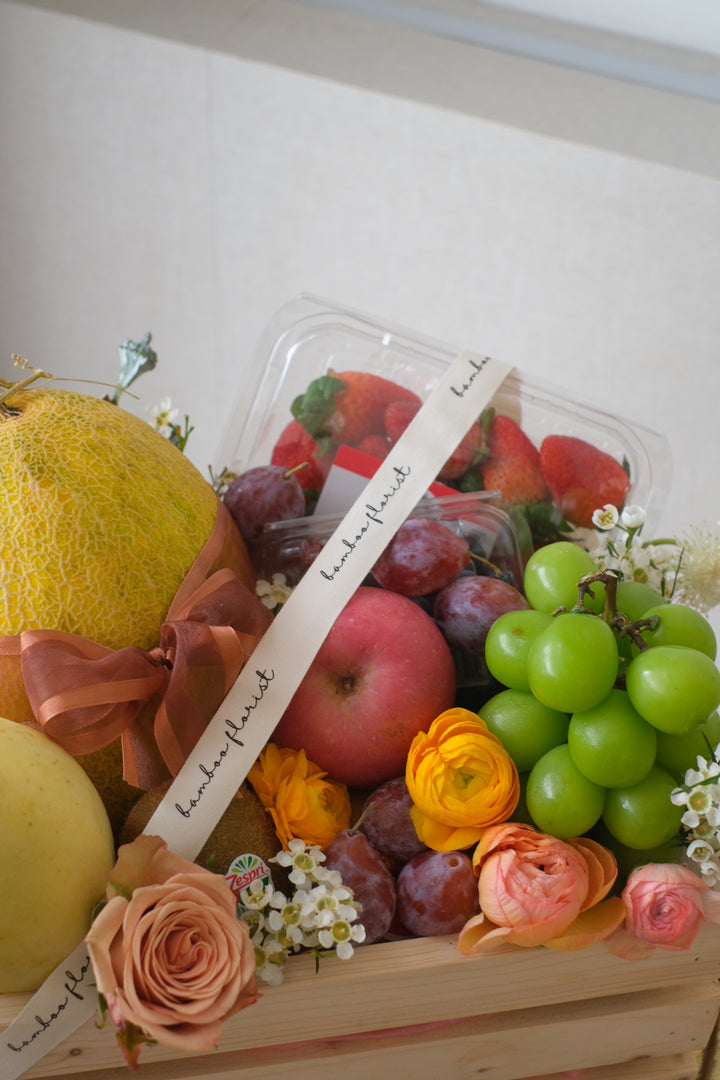 Finding the perfect fruit basket to delivery in Penang? "The Covent Fruit Co"   - fresh fruits deliver in a wooden crate, this set includes grapes, kiwis, apples, dragon fruit, strawberries, blueberries, plum & honeydew (seasonal). Finishing off with fresh flowers of the day. Same day fruit basket delivery in Penang