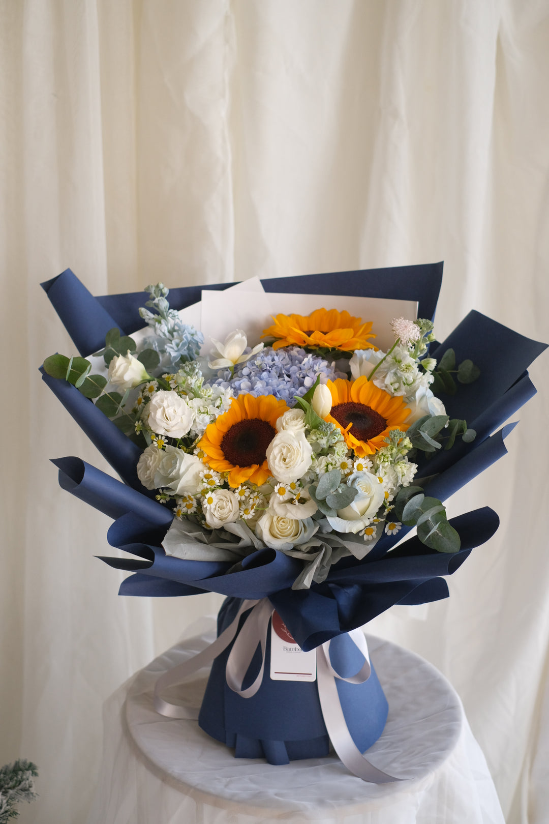 Dream Chaser bouquet by Penang florist Bamboo Green – featuring blue hydrangeas, blue roses, and chamomile. Trusted florist brand for 40 years.