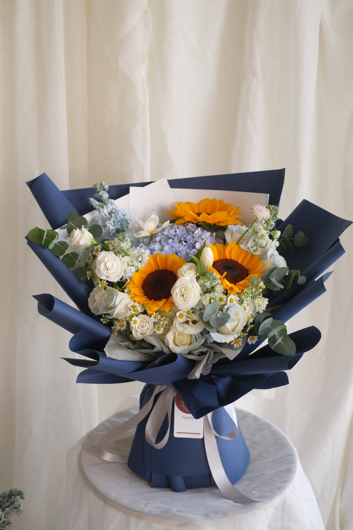 Dream Chaser bouquet by Penang florist Bamboo Green – featuring blue hydrangeas, blue roses, and chamomile. Trusted florist brand for 40 years.