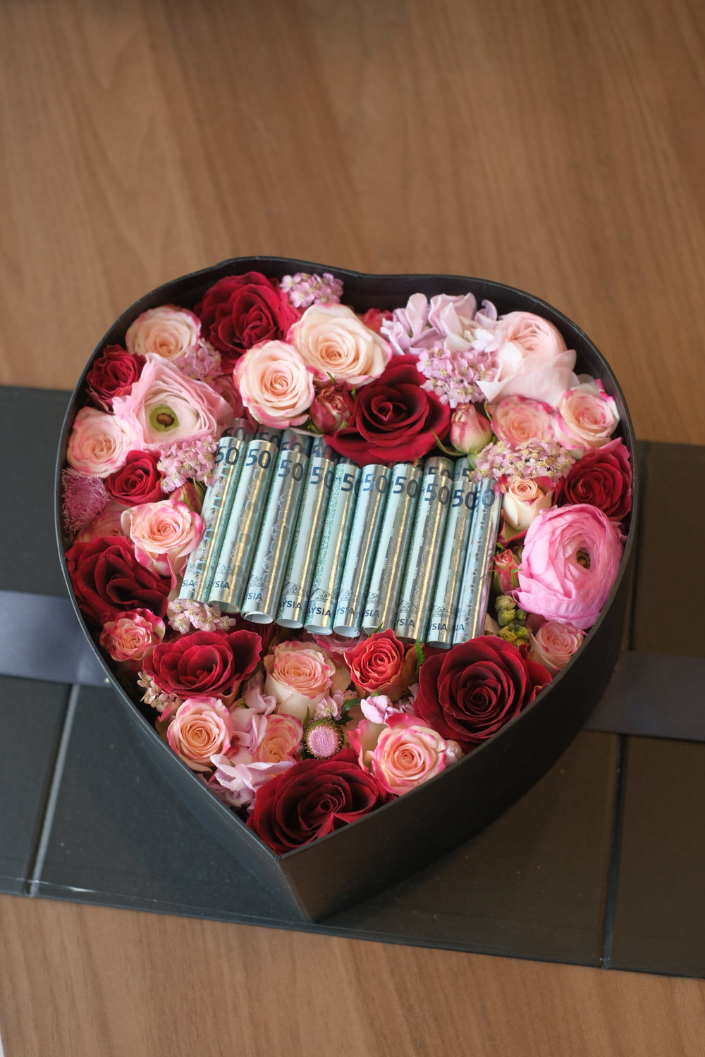 cash and flowers in bloom box