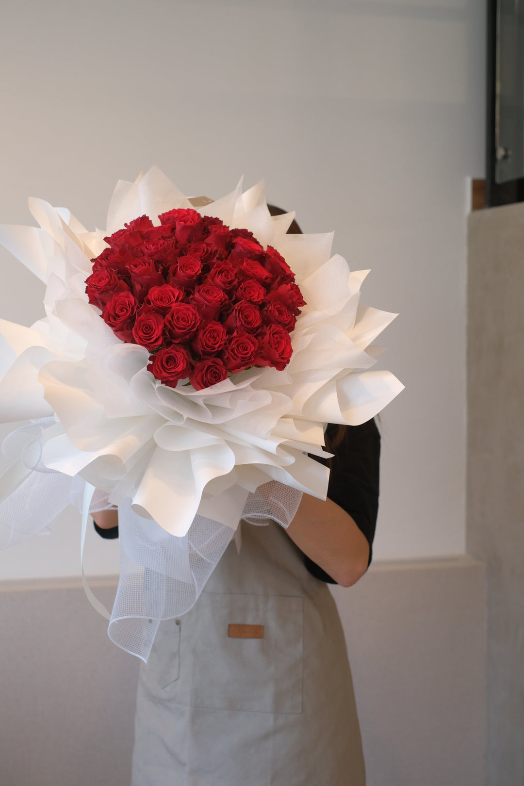 Image of stunning red roses elegantly presented in white wraps, ideal for creating a showstopping display for your special occasions.