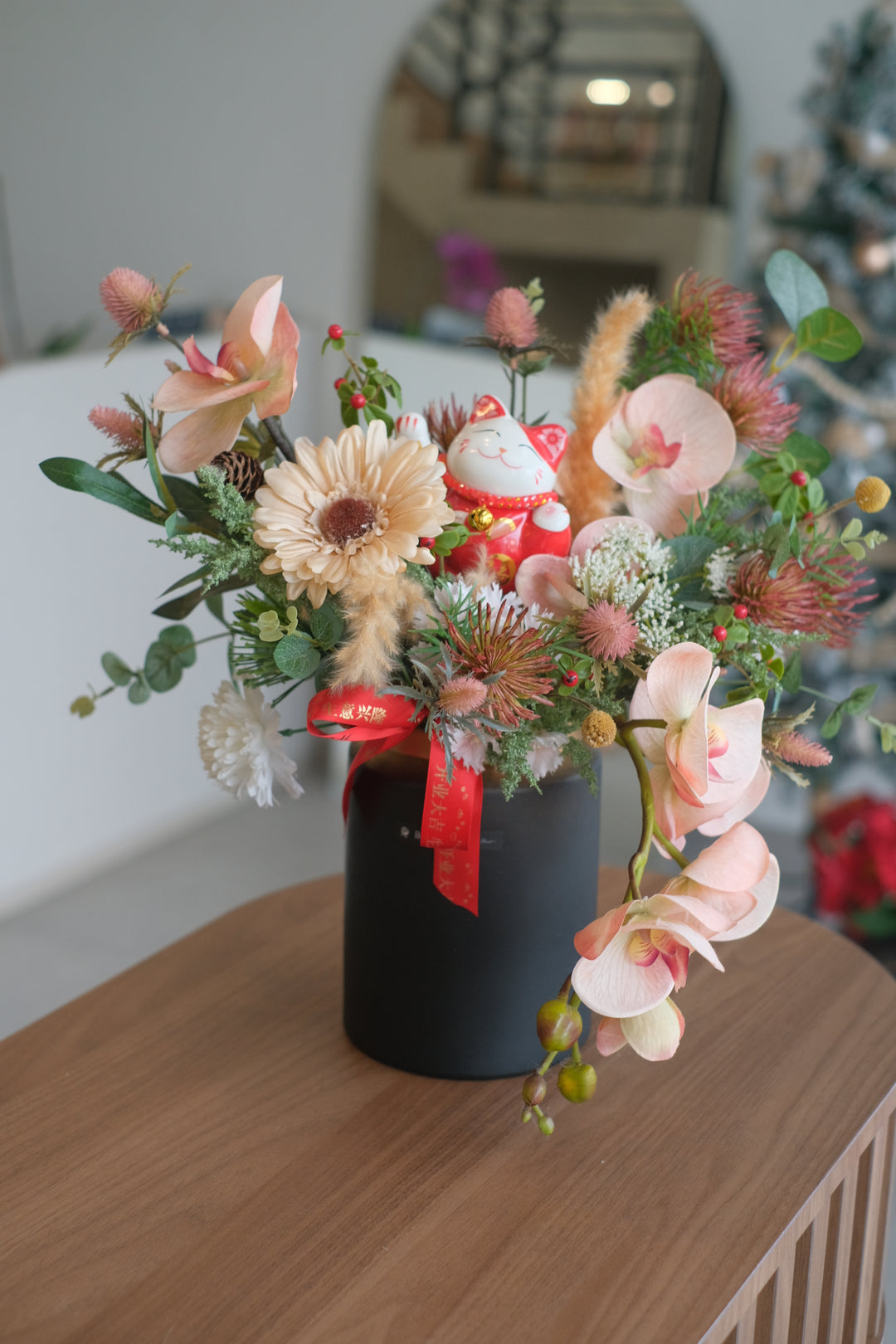 Artificial arrangement.  Set the right mood for celebrating with our beautiful tabletop artificial flowers dressed in wooden trimmings to welcome family and friends or welcome a new business venture.