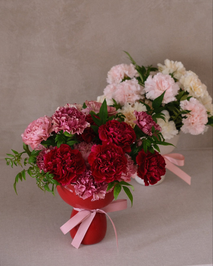 Hand arranging carnations for Mother’s Day bouquet at Bamboo Green Florist, Penang’s trusted local florist