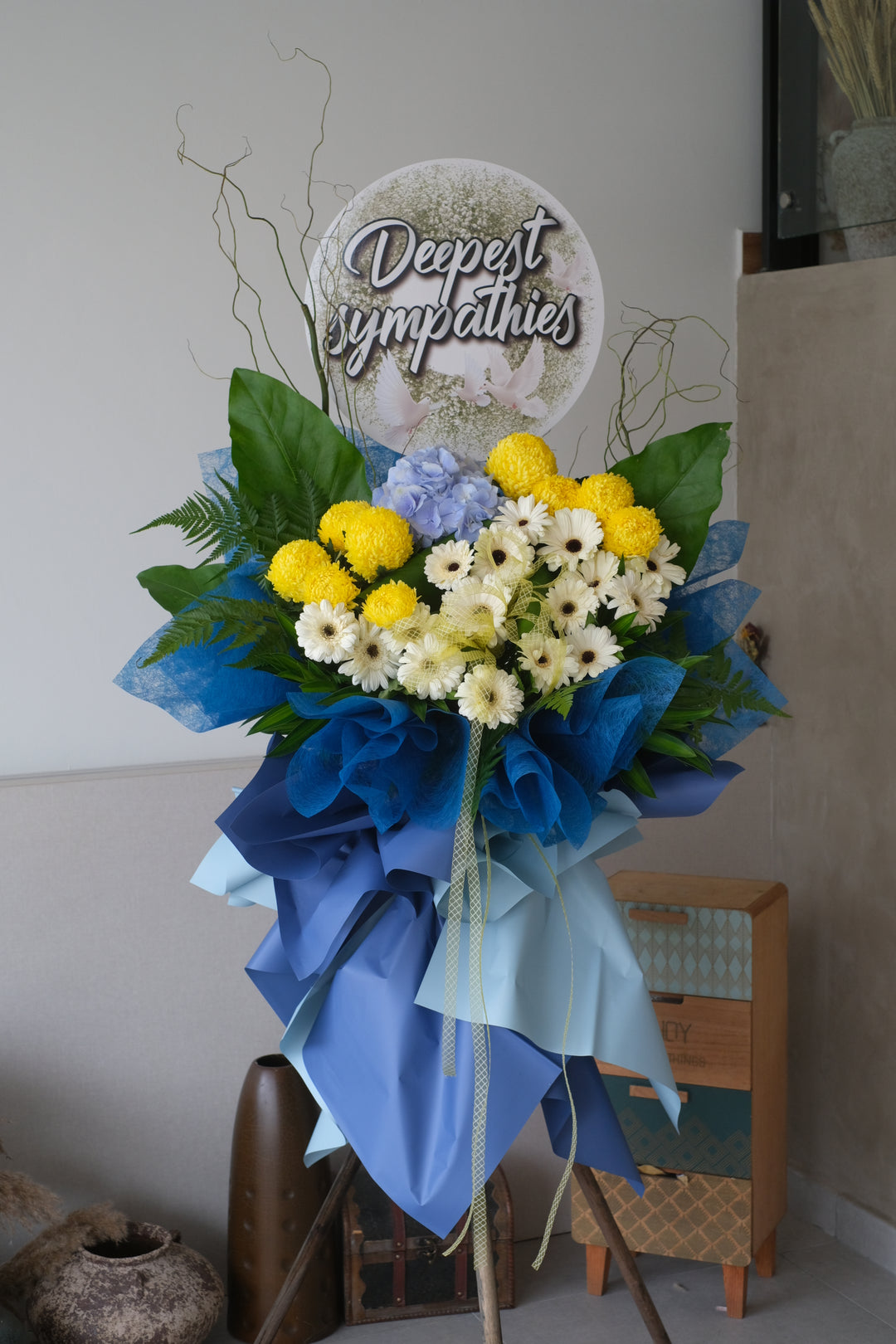 condolences flower penang, flower arrangement, white daisy in blue wrapping paper, yellow pompom with blue hydrangea