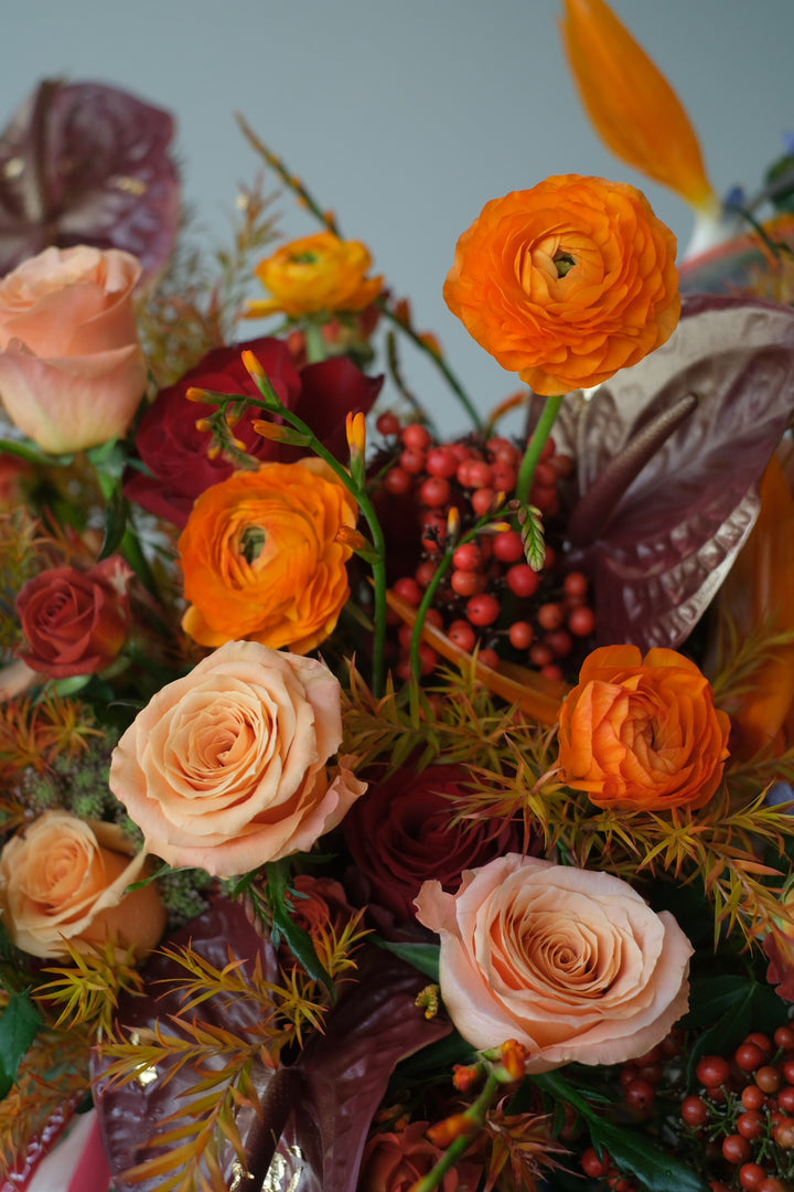 Omakase floral arrangement by Bamboo Florist, featuring vibrant orange blooms in a ceramic pot with Chinese design, inspired by Mandarin Oriental elegance. Designed to surprise and delight.