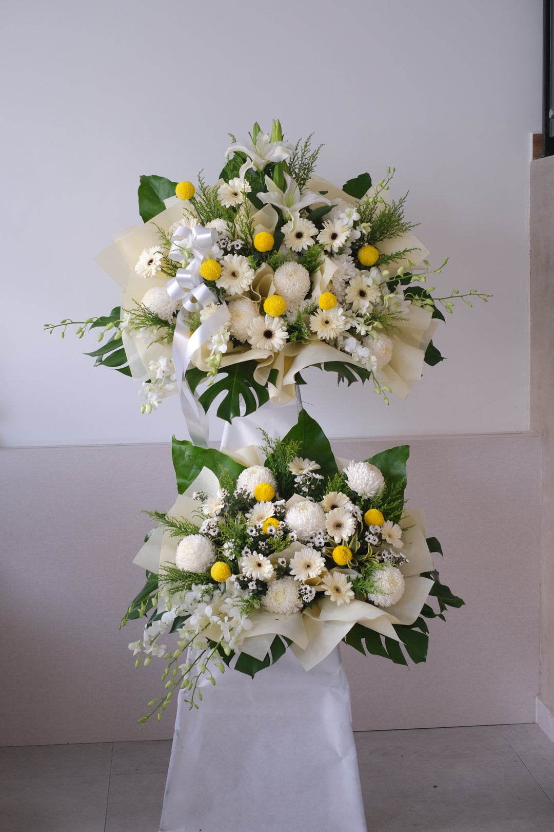 Same-day condolences flowers delivery in Penang - A serene arrangement of white hydrangeas, gerberas, roses, fillers, and greens, expressing love and remembrance during a difficult time."