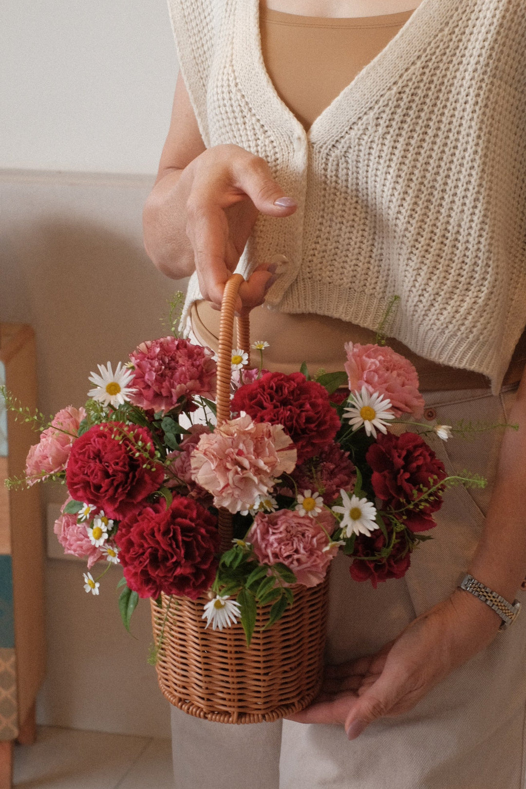 Mixed bold carnations in a handwoven basket