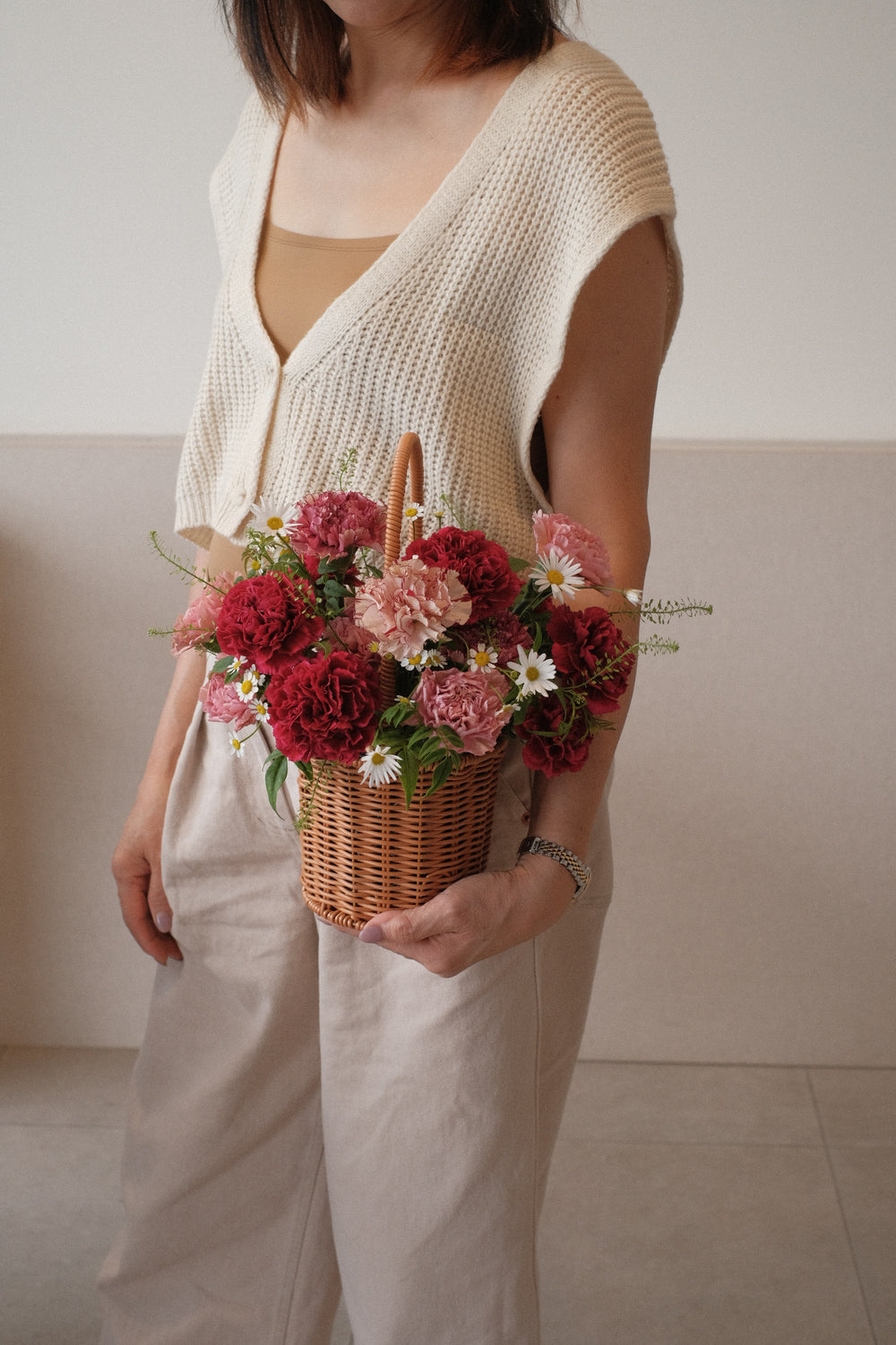 Mixed bold carnations in a handwoven basket
