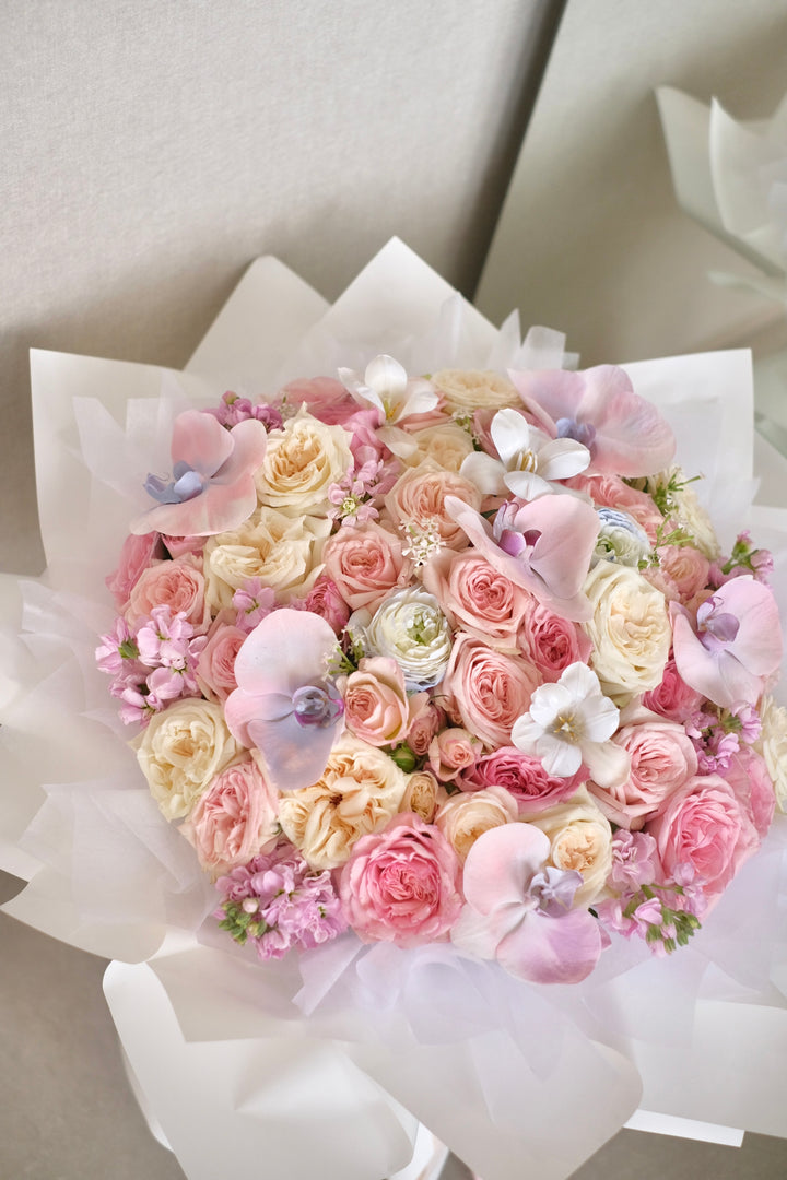 Elegant mixed bouquet featuring roses and Phalaenopsis orchids in white, pink, and blue varieties. Order online from Bamboo Green Florist, your trusted Penang florist with delivery.