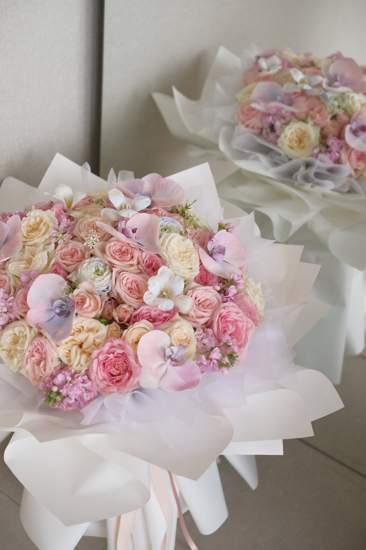 Elegant mixed bouquet featuring roses and Phalaenopsis orchids in white, pink, and blue varieties. Order online from Bamboo Green Florist, your trusted Penang florist with delivery.