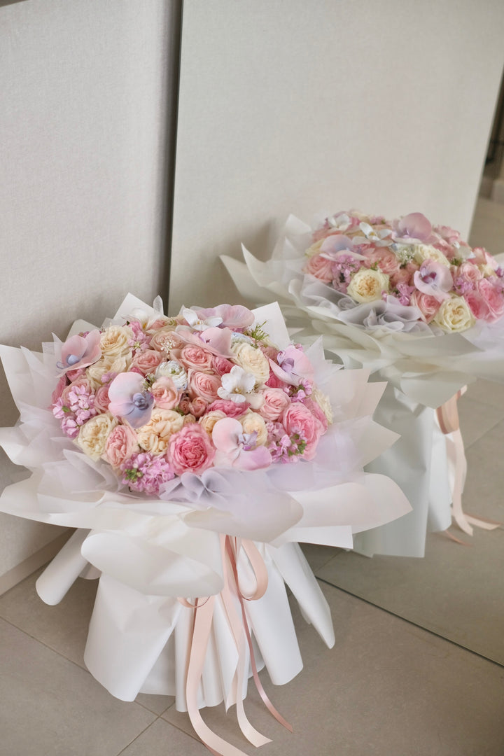 Elegant mixed bouquet featuring roses and Phalaenopsis orchids in white, pink, and blue varieties. Order online from Bamboo Green Florist, your trusted Penang florist with delivery.