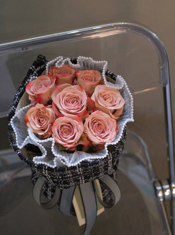 A passionate bouquet of premium imported red roses, laced with pearls and wrapped in coco weave. Shop online at Bamboo Green Florist, your trusted Penang florist.