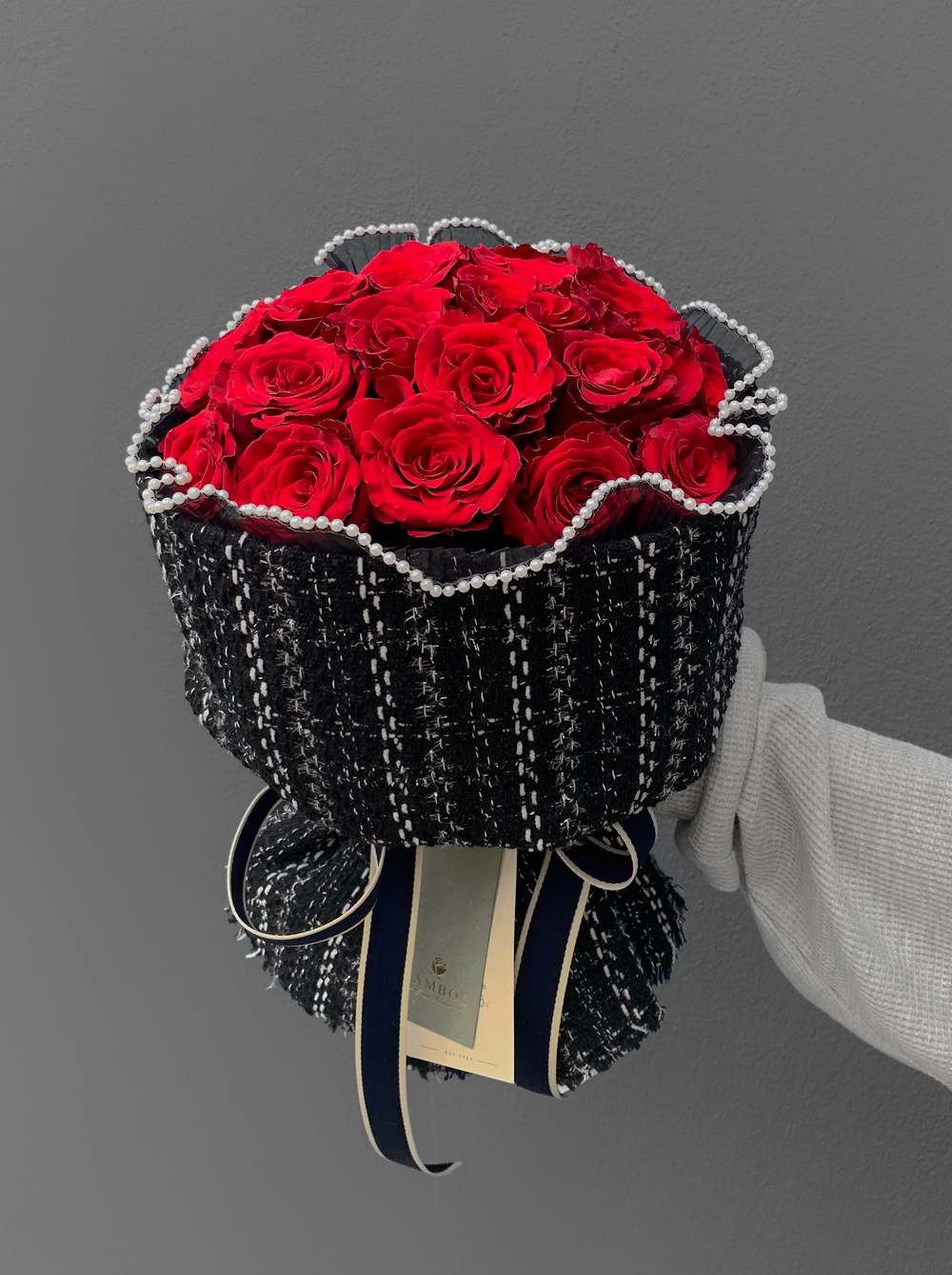 A passionate bouquet of premium imported red roses, laced with pearls and wrapped in coco weave. Shop online at Bamboo Green Florist, your trusted Penang florist.