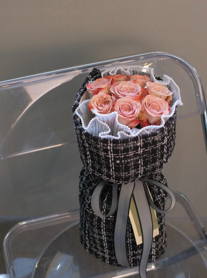 A passionate bouquet of premium imported red roses, laced with pearls and wrapped in coco weave. Shop online at Bamboo Green Florist, your trusted Penang florist.