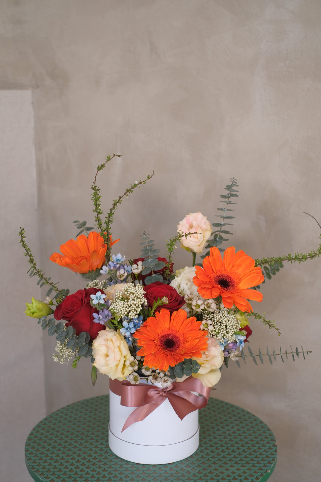 Bright orange gerbera and rose arrangement, bringing warmth and happiness like a sunny day. Perfect for home or office. Order now from Bamboo Green Florist.