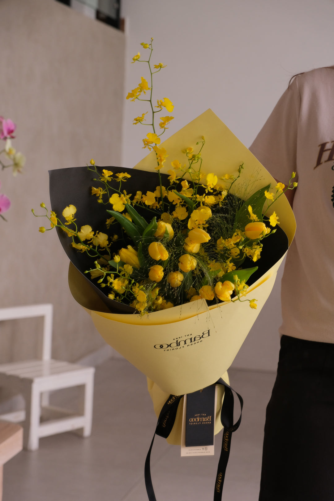 Sunspell bouquet — yellow tulips and yellow dancing lady orchids wrapped in sculpted wrap by Bamboo Green Florist Penang