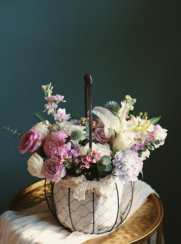 Elegant flower basket featuring purple and white seasonal blooms. Perfect for birthdays, anniversaries, and housewarming. Order from Penang florist with same-day delivery!