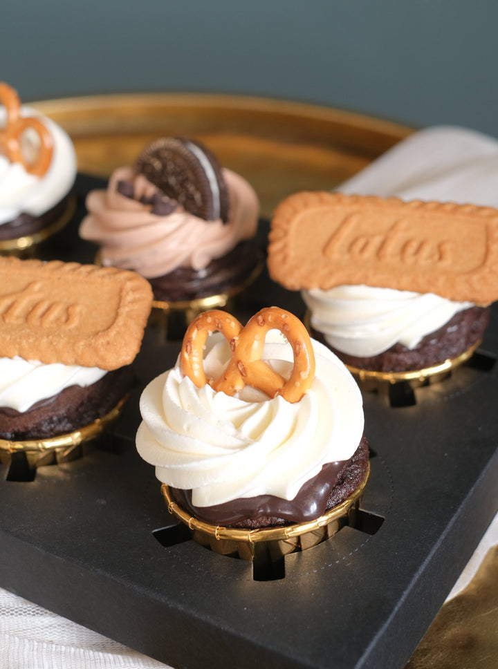 Chocolate cupcakes topped with Lotus biscuits, Oreo, & pretzels by Bamboo Green Florist – a delightful treat in Penang. Order now for delivery!