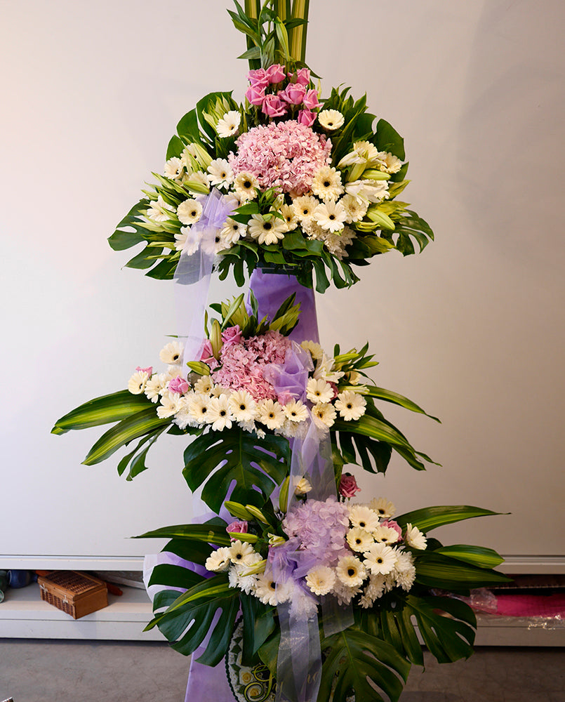 Let these beautiful flowers help you express your feelings and say farewell to a loved one at this sad time. An assemblage of cream gerberas, pink hydrangeas and yam roses with bed of poms. For same day condolences flowers delivery in Penang.