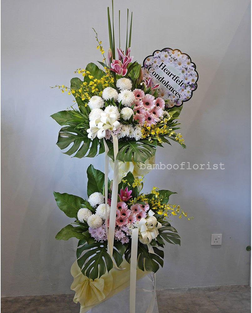 2 tier sympathy arrangement for same day condolences flowers delivery in Penang.