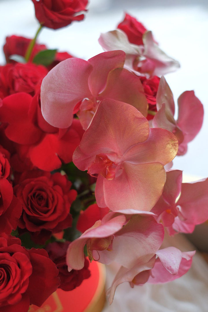 Charming is the perfect gift to express passionate love. Featuring red roses and Phalaenopsis, this elegant arrangement symbolizes bold sentiments. Same-day delivery in Penang.