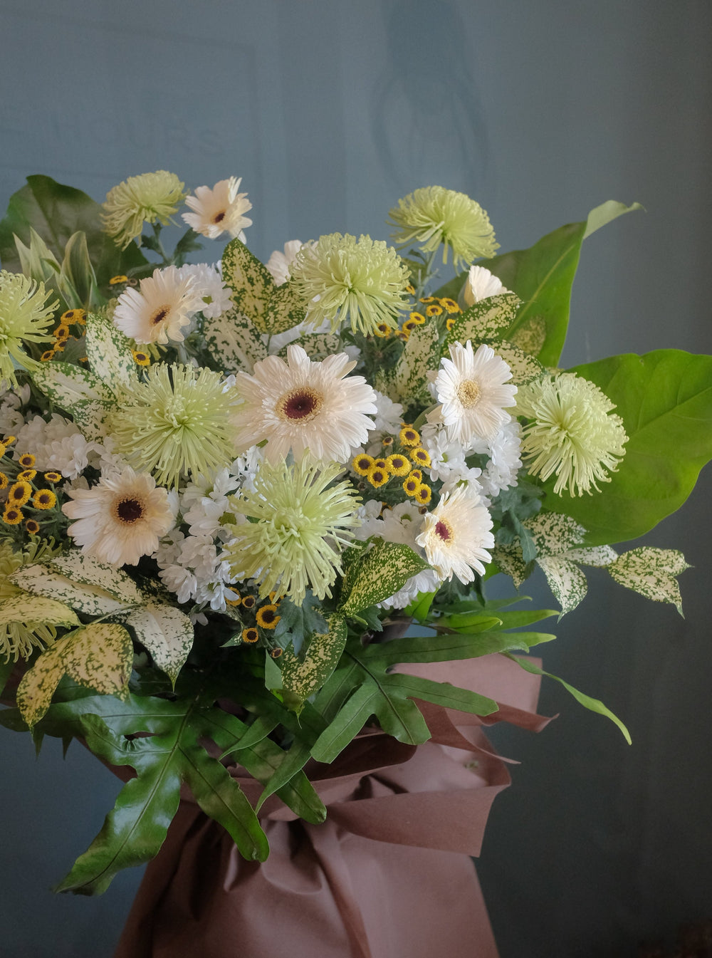 The loss of a loved one can be hard to accept. To help offer your condolences, and remember the joy they brought in life, we've put together lilies, gerberas, chrysanthemums, dancing lady, anthuriums, pompoms and lush ferns to honor your loved one. Send your condolences, or remember their life with one last Celebration. For same day condolences flowers delivery in Penang.