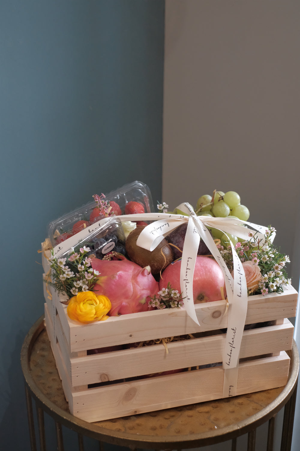 Finding the perfect fruit basket to delivery in Penang? "The Covent Fruit Co"   - fresh fruits deliver in a wooden crate, this set includes grapes, kiwis, apples, dragon fruit, strawberries, blueberries, plum & honeydew (seasonal). Finishing off with fresh flowers of the day. Same day fruit basket delivery in Penang