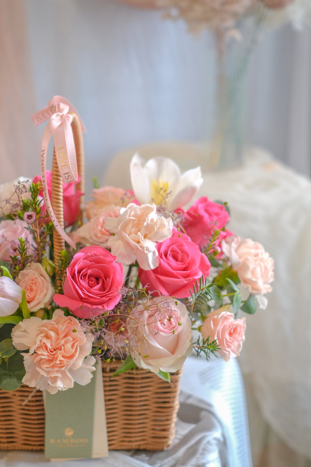 Warm and blushing flower basket with carnations, hot pink roses, tulips, and lush leaves. Perfect Mother’s Day gift. Same-day delivery in Penang & Butterworth.