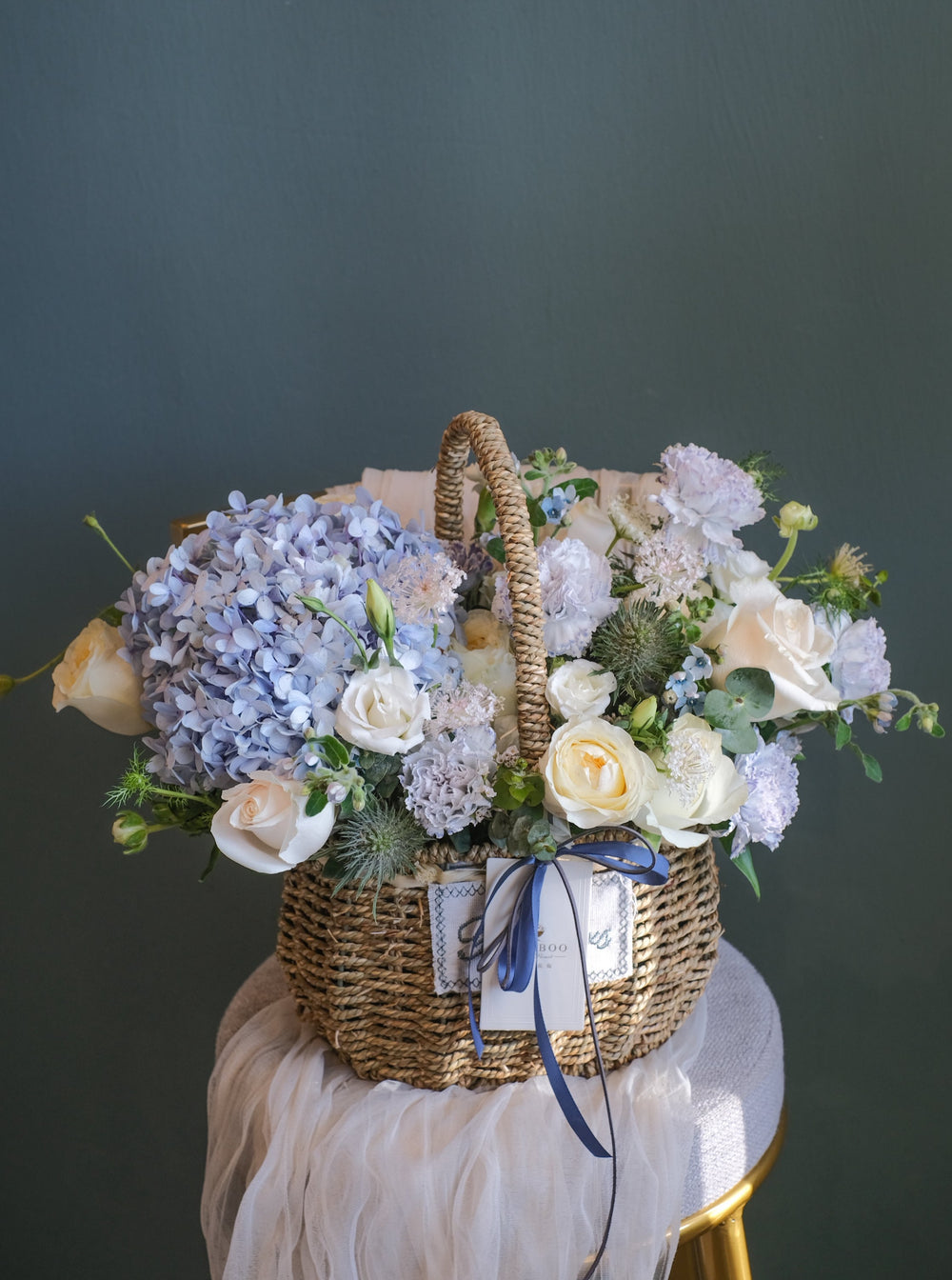 Elegant blue, cream & white flower arrangement featuring hydrangeas, roses, carnations & eustomas. Perfect for any celebration. Same-day delivery in Penang!