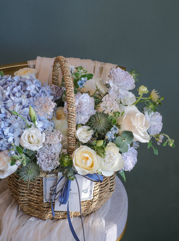 Elegant blue, cream & white flower arrangement featuring hydrangeas, roses, carnations & eustomas. Perfect for any celebration. Same-day delivery in Penang!