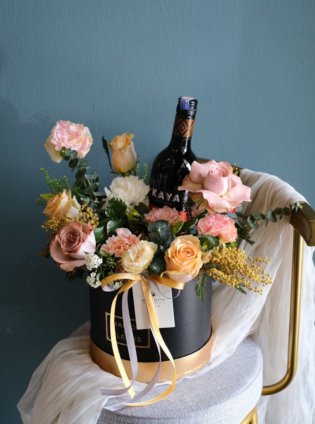 Marvelous warm-hued arrangement of Eustomas, Roses, carnations & fillers in a box, with the option to add wine. Order online from Penang's trusted florist!