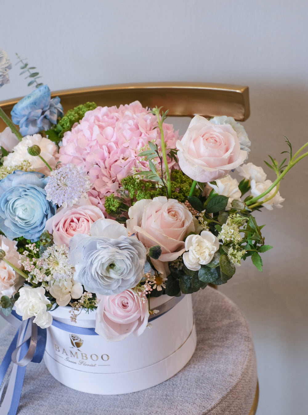This bloom box features a recessed medley of romantic pink and light blue blooms. Penang florist with same-day delivery, order online for the perfect floral gift