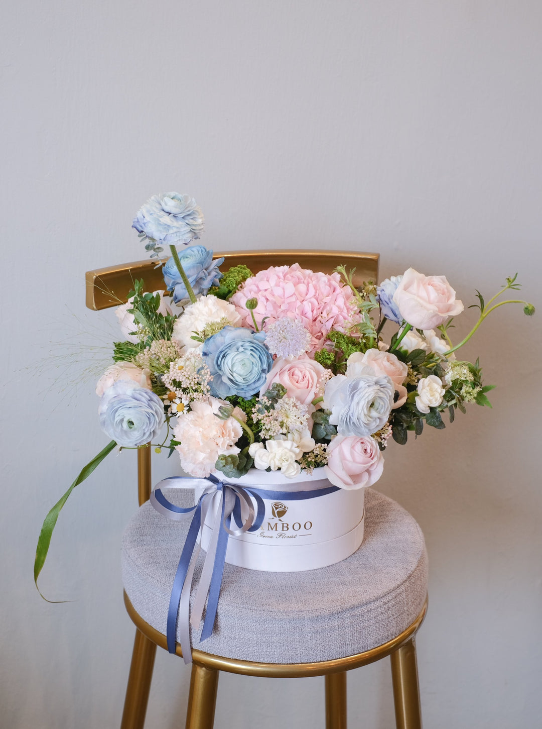 This bloom box features a recessed medley of romantic pink and light blue blooms. Penang florist with same-day delivery, order online for the perfect floral gift.