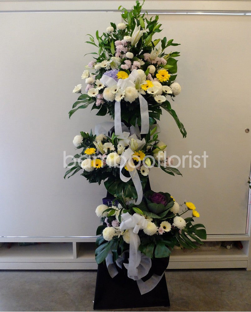 The loss of a loved one can be hard to accept. To help offer your condolences, and remember the joy they brought in life, we've put together lilies, brassica, white daisies gerberas, anthuriums, chrysanthemums, pompoms and lush ferns to honor your loved one. For same day condolences flowers delivery in Penang.