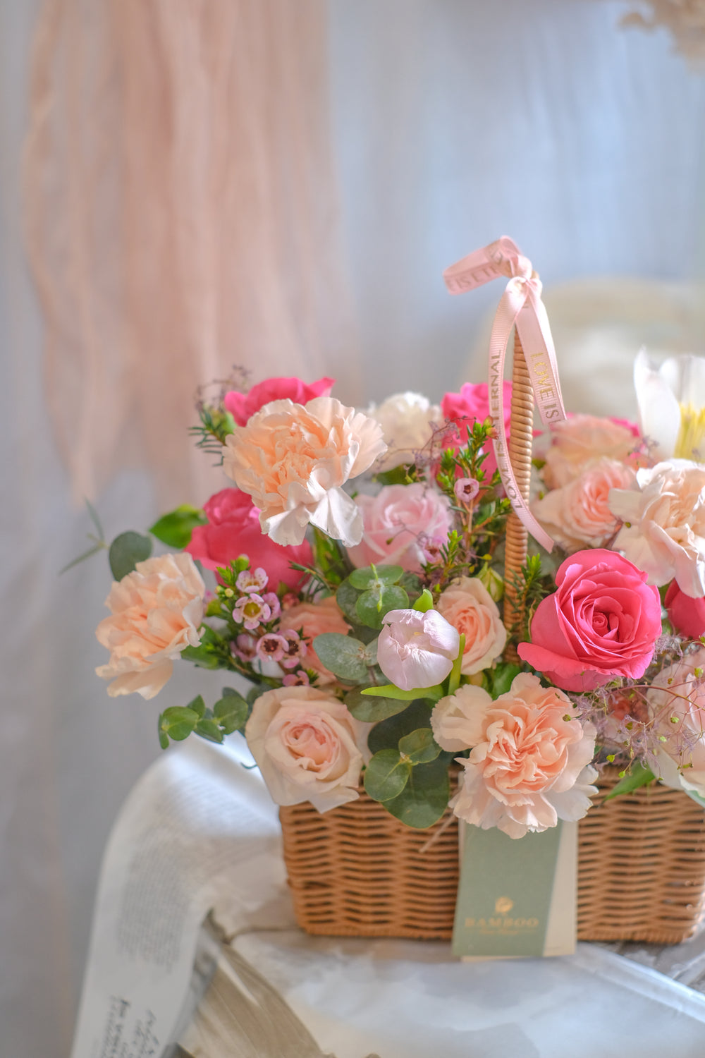 Warm and blushing flower basket with carnations, hot pink roses, tulips, and lush leaves. Perfect Mother’s Day gift. Same-day delivery in Penang & Butterworth.