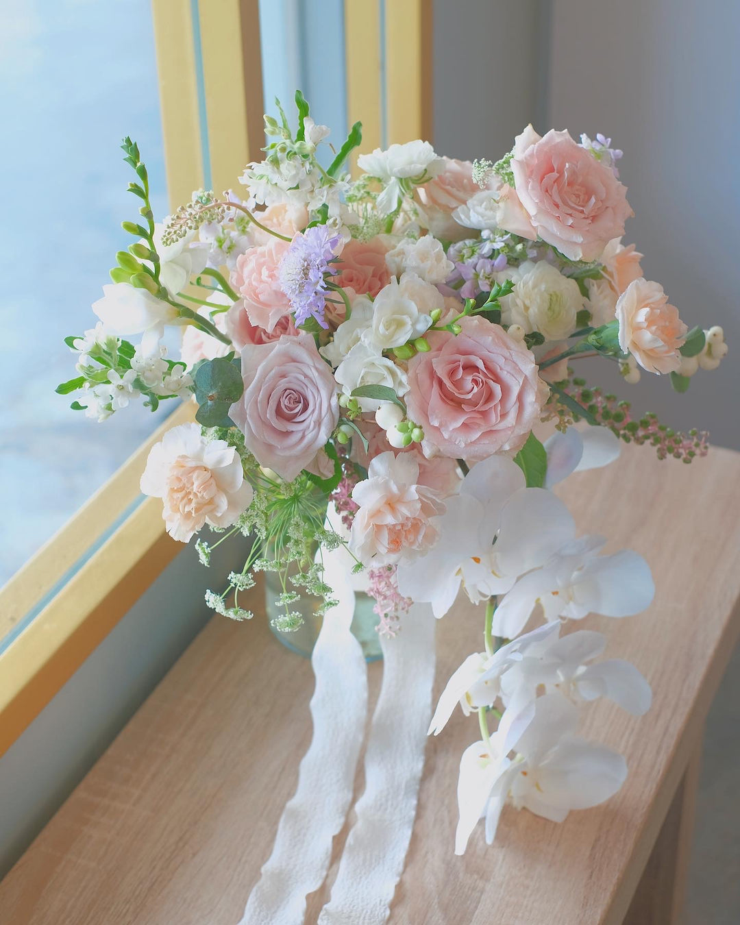 Elegantly arranged in a glass vase, this bouquet features soft, elegant blooms perfect for housewarmings, birthdays, baby showers, or engagements. Same-day delivery by Penang Florist.