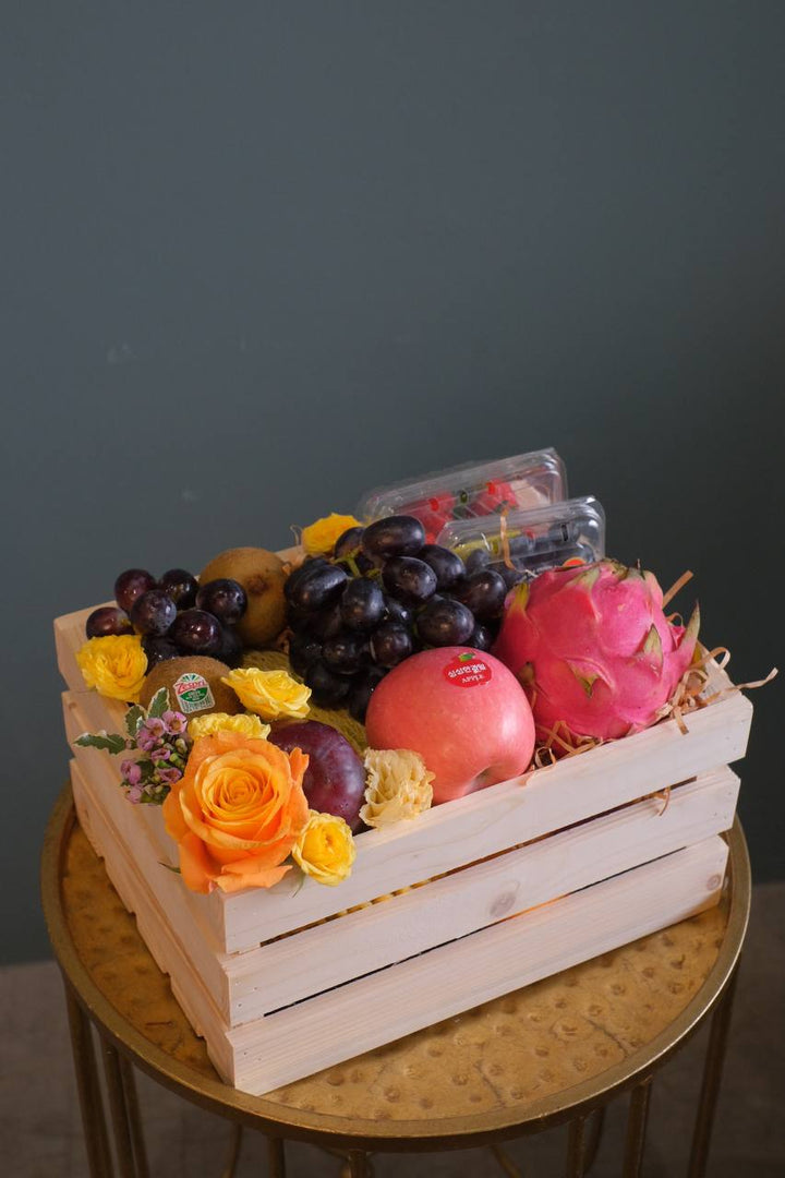Finding the perfect fruit basket to delivery in Penang? "The Covent Fruit Co"   - fresh fruits deliver in a wooden crate, this set includes grapes, kiwis, apples, dragon fruit, strawberries, blueberries, plum & honeydew (seasonal). Finishing off with fresh flowers of the day. Same day fruit basket delivery in Penang