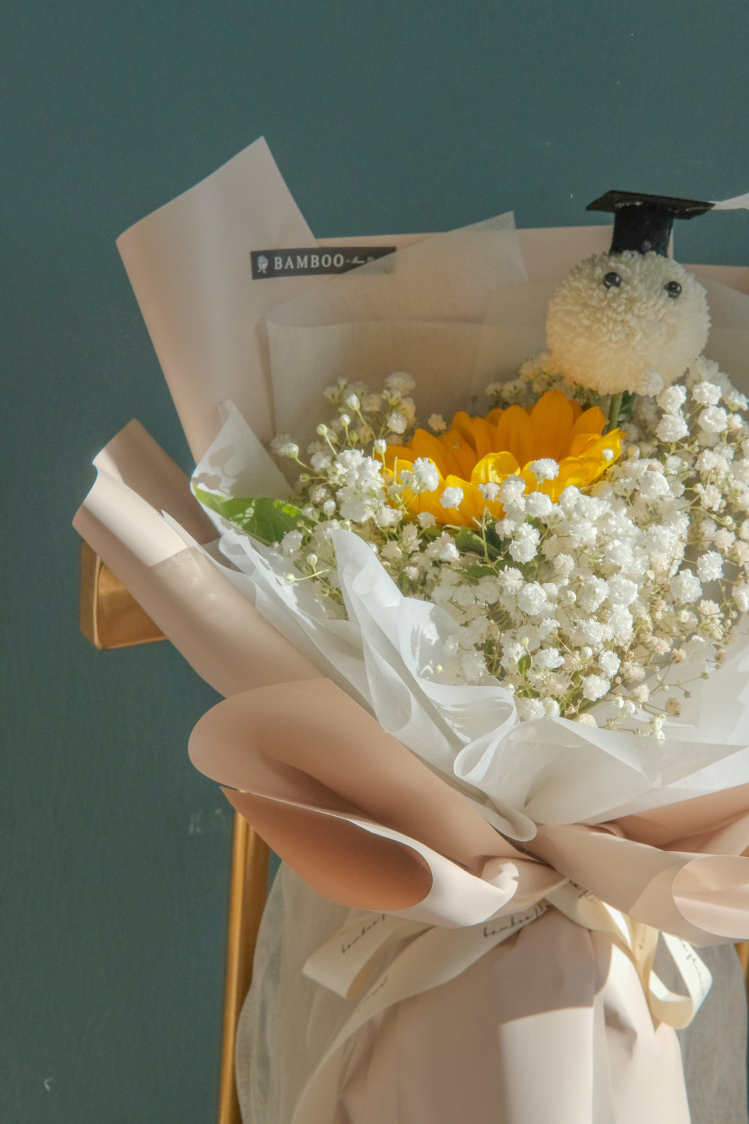 Graduation bouquet with sunflower, baby breath & a cute bear. Perfect for celebrating their achievement! Penang florist, same-day delivery available.