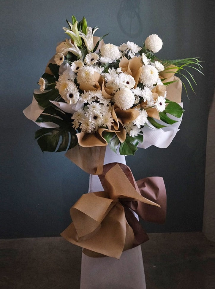 This lovely floral testament to the circle of life and love evokes beautiful memories even during the most difficult times.  For same day condolences flowers delivery in Butterworth