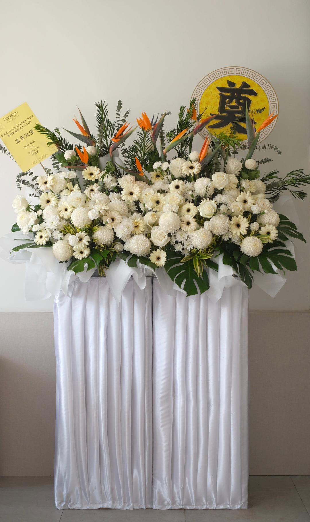 Condolences White Box Arrangement by Penang Bamboo Green Florist, featuring a harmonious blend of Bird of Paradise, Roses, Daisies, Carnations, and Ping Pongs, elegantly arranged in a pristine white box to convey sympathy and support