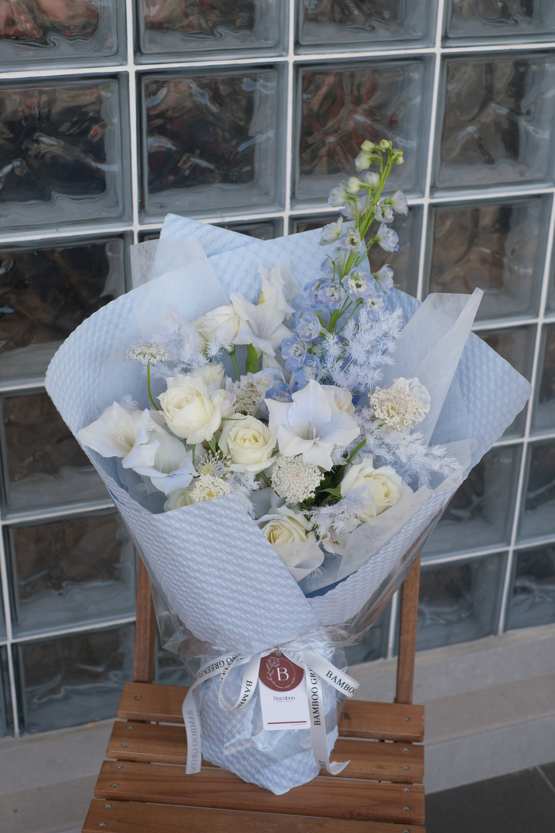 Elegant blend of blue and white seasonal flowers, creating a timeless and serene bouquet. Order online from Bamboo Green Florist, your trusted Penang florist with delivery.