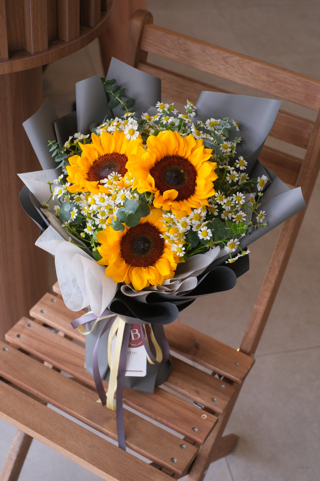 Blooming Future to Graduation bouquet by Bamboo Green Florist – featuring 3 sunflowers and chamomile