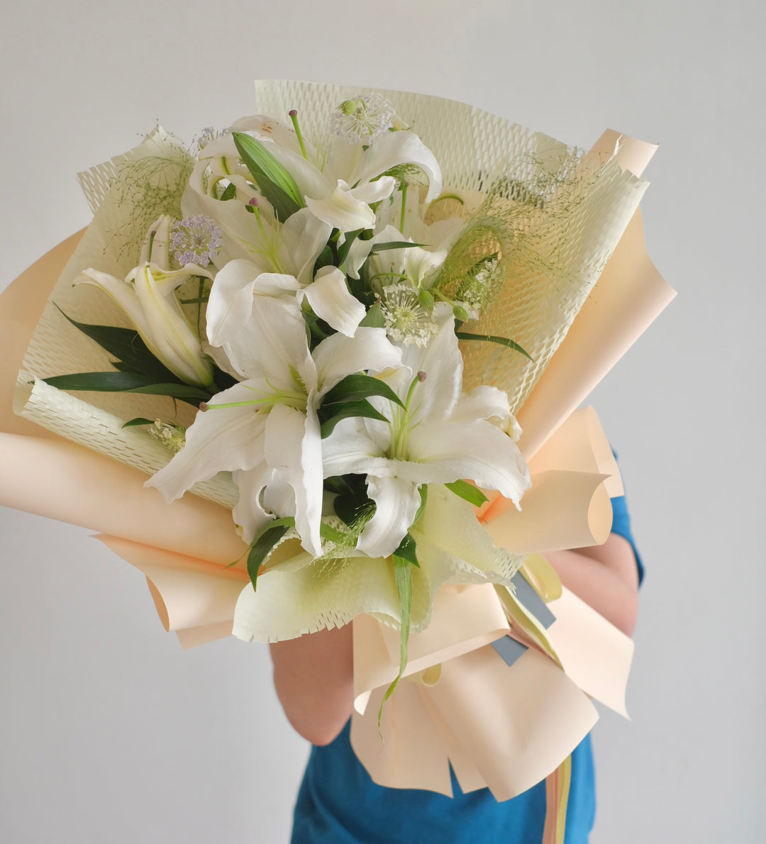 Elegant white bouquet of lilies, available for same-day delivery to Bukit Mertajam and Alma by Bamboo Green Florist, Penang's top online florist