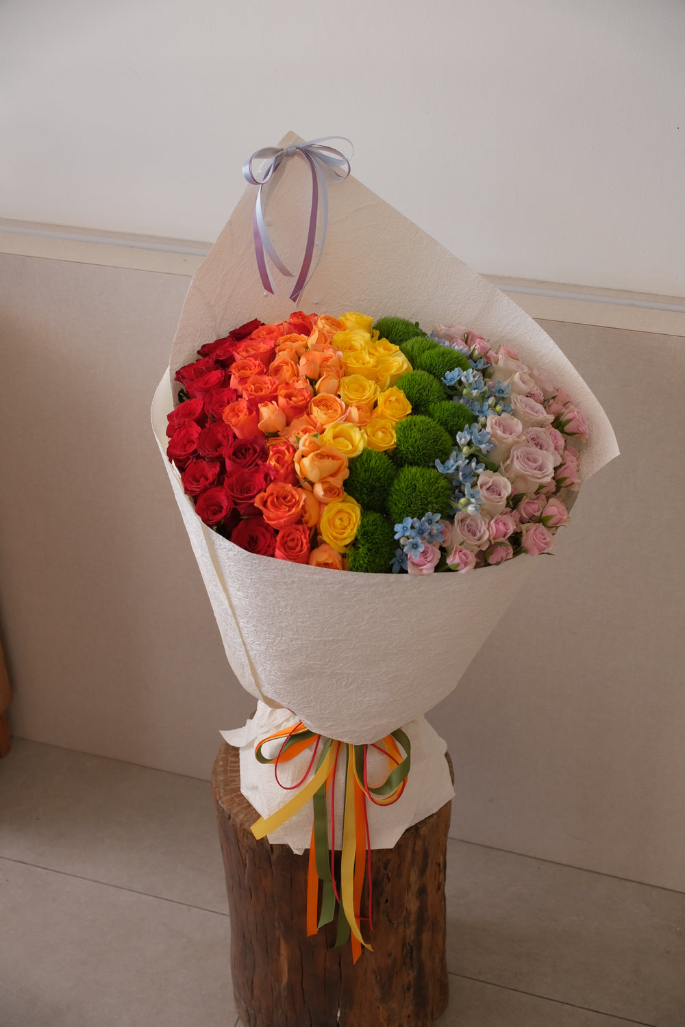 Bouquet of flowers with a rainbow color , florist delivery in penang 